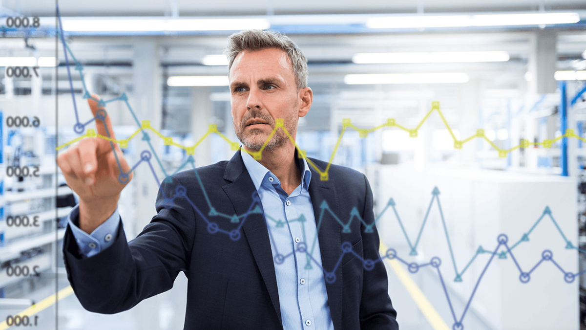 Business professional interacting with digital data charts, analyzing performance metrics and manufacturing analytics.
