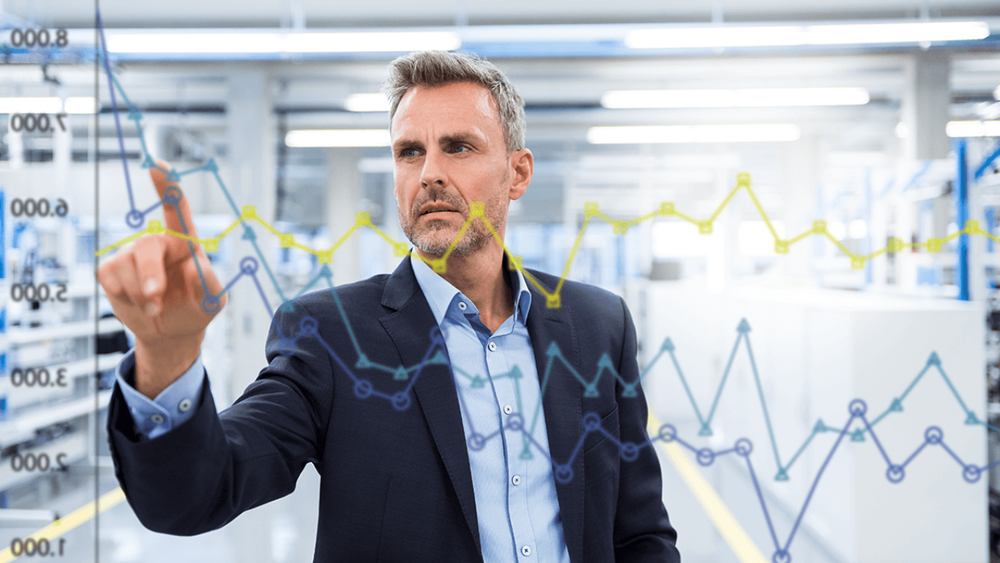 Business professional interacting with digital data charts, analyzing performance metrics and manufacturing analytics.